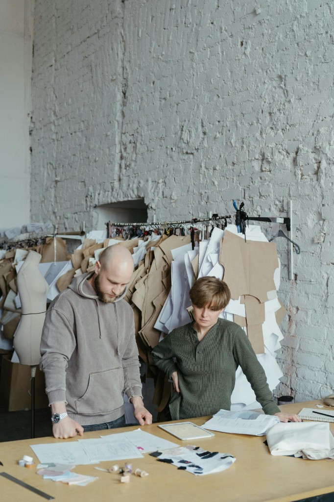 Designers reviewing sketches and patterns in a studio